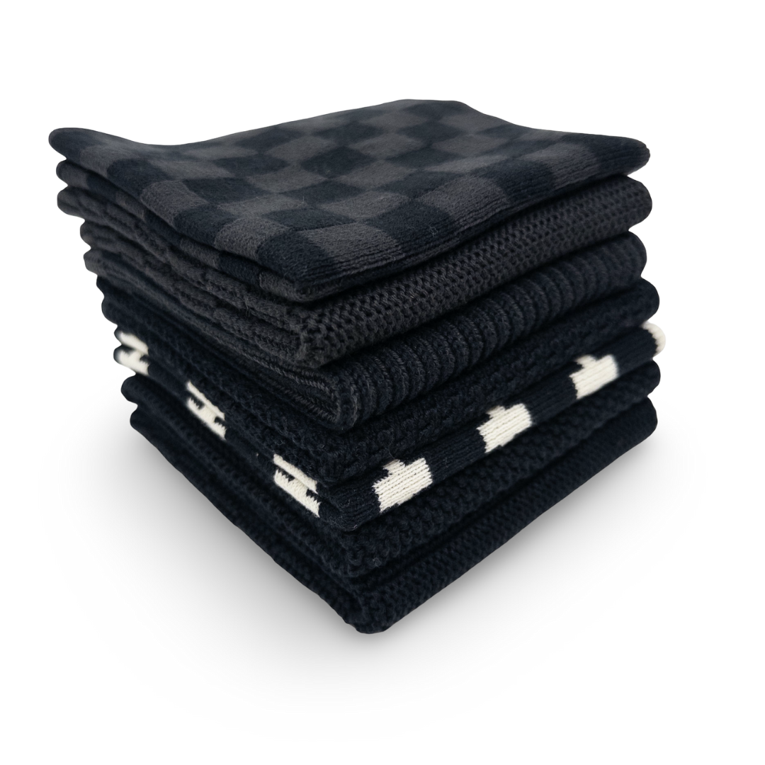 Stack of folded black and white checkered dishcloths on a white background